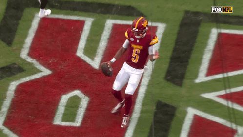 a football player with the number 5 on his jersey is running on the field