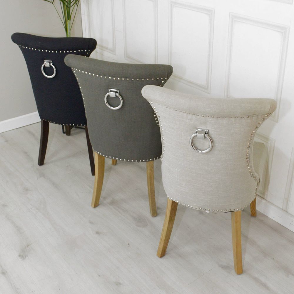 A set of grotesque chairs (one white, one grey, one black) which would otherwise be fine but some plonker thought it would be sensible to strap a door knocker to the back of it. 