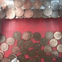 Gif of coin pusher machine commonly found in amusement arcades.