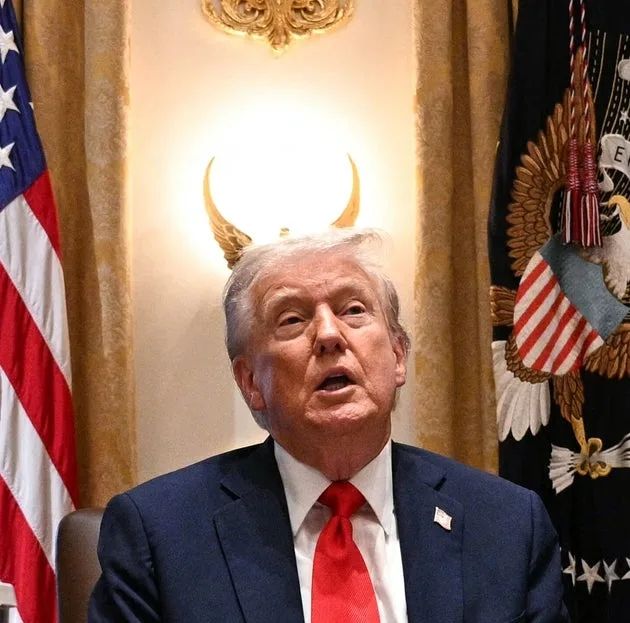 Photo of Trump in front of a wall ornament that creates the illusion if him having devil horns...