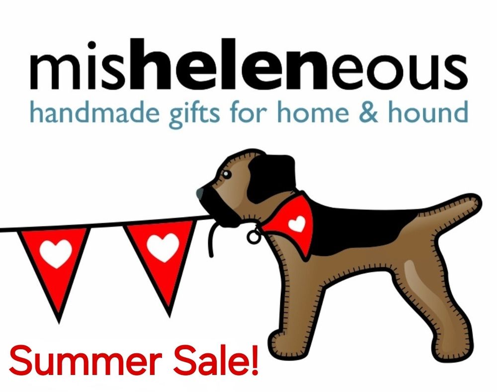 The misheleneous brand border terrier logo on a poster advertising a Summer Sale. The dog has red and white heart motif bunting in its mouth