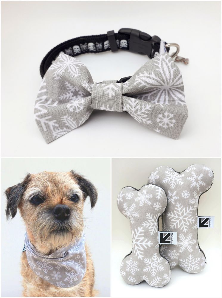 A collage of 3 images showing silver and white snowflake print grey fabric dog bone toys, a bow tie attached to a black dog collar and a dog bandana modelled by Heidi border terrier. All handmade by misheleneous