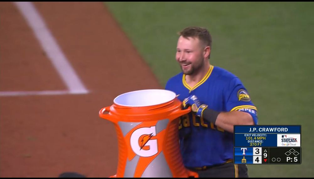 Cal Raleigh being absolutely thrilled that he gets to pour Gatorade over his best friend in the entire world: JP Crawford after Crawford hit a home run to beat the lousy Texas Rangers.