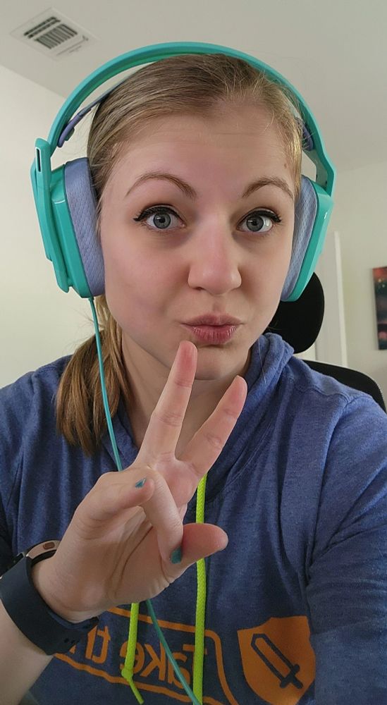 Mxiety putting up a piece sign wearing headphones