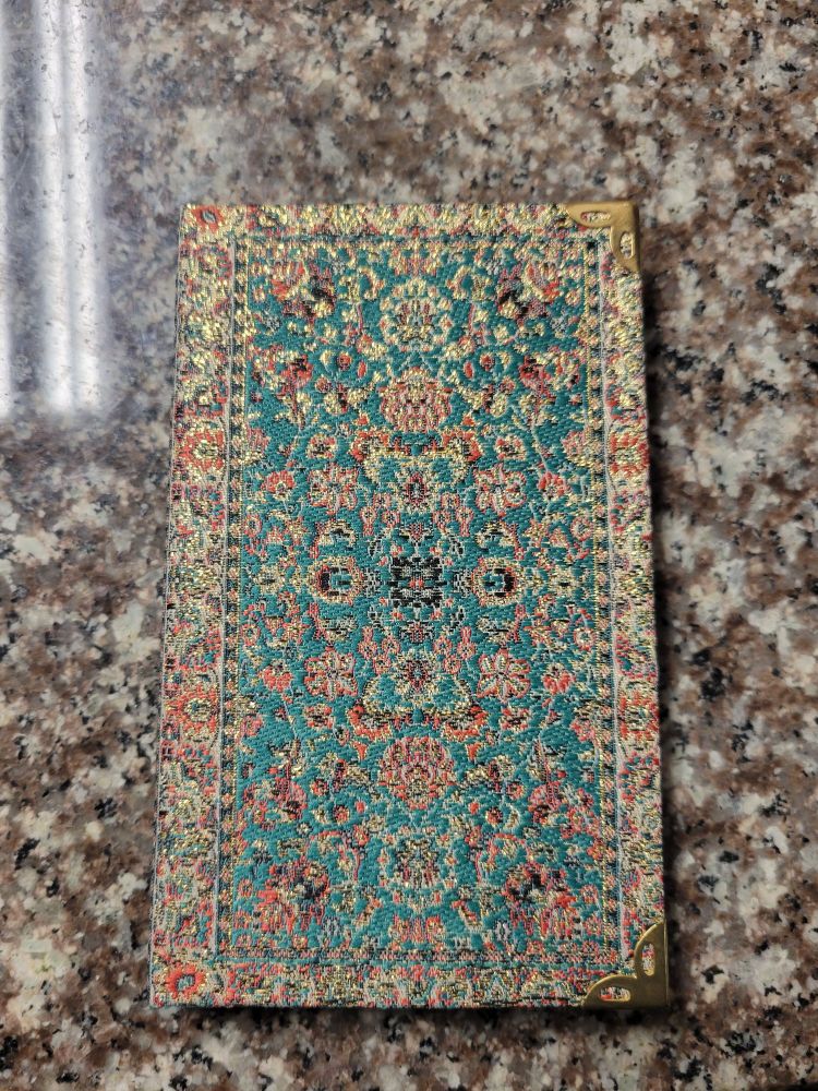 A notebook in the pattern of a Turkish rug.