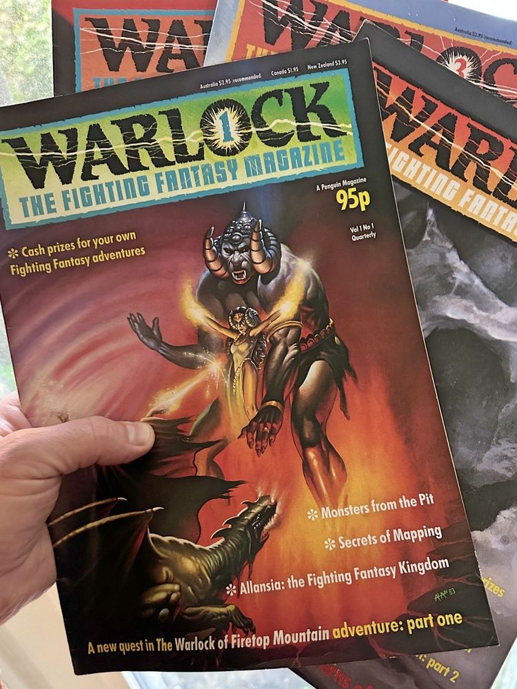 A hand holds four copies of Warlock: The Fighting Fantasy Magazine from 1984, with the price visible (95p).