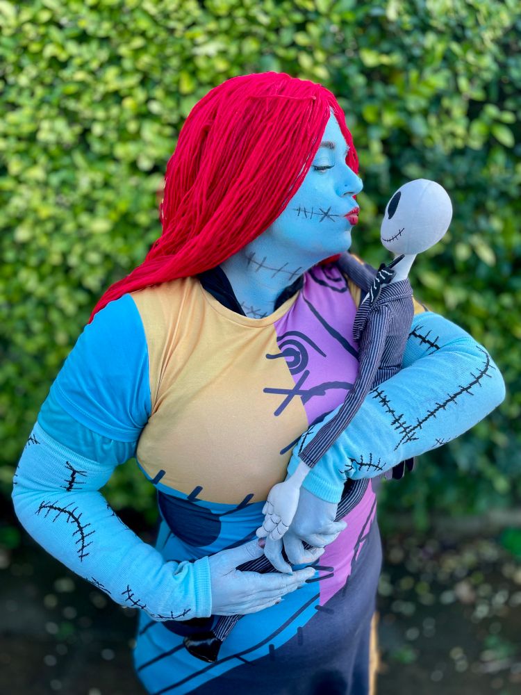 MrsHackenbush dressed as Sally again, but with a Jack Skellington doll she is about to kiss