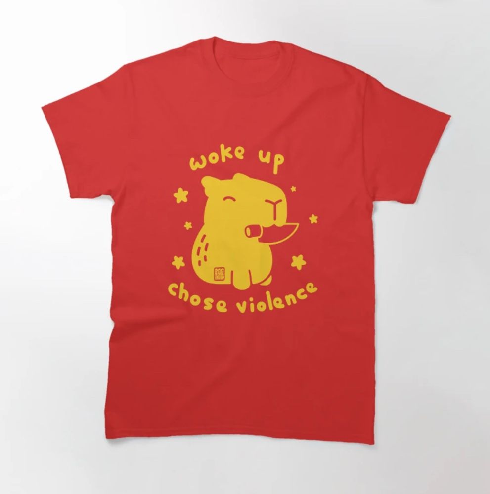 Shirt sample: yellow on red graphic of a capybara with a knife in its teeth. Slogan reads “woke up. Chose violence. “