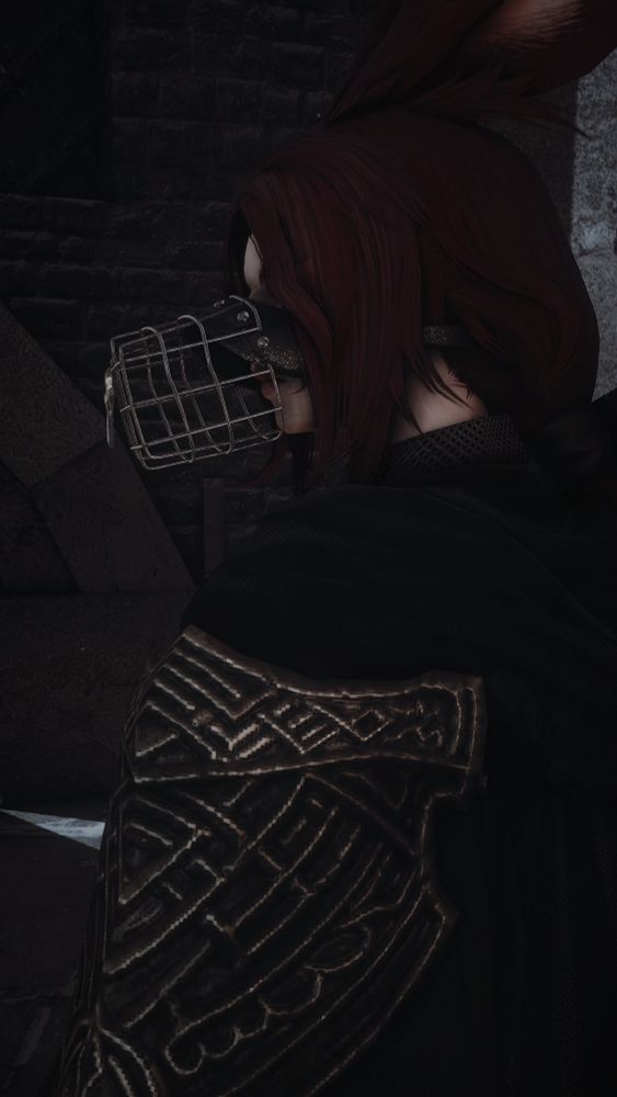 Gaspard Bourreau looking back over her shoulder towards the viewer. Her eyes are obscured, and she is wearing a muzzle.