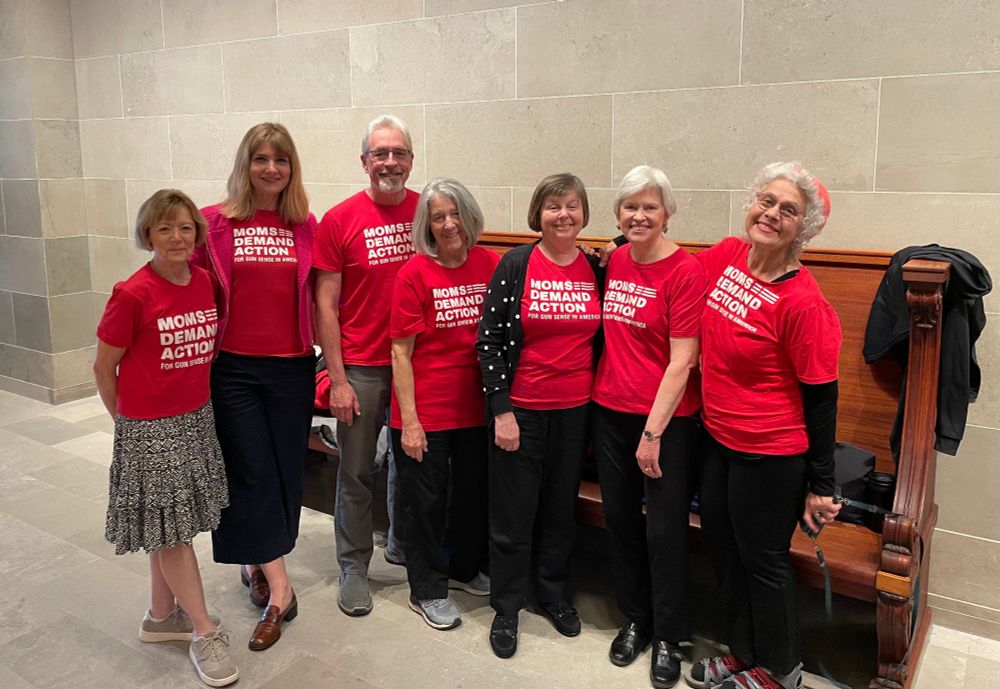 A group of Missouri Moms Demand Action volunteers in a hallway at the Missouri State Capitol at the end of Senate hearings