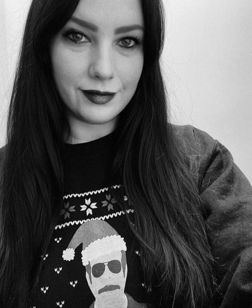 Black and white selfie of me wearing a Ted Lasso Christmas sweatshirt