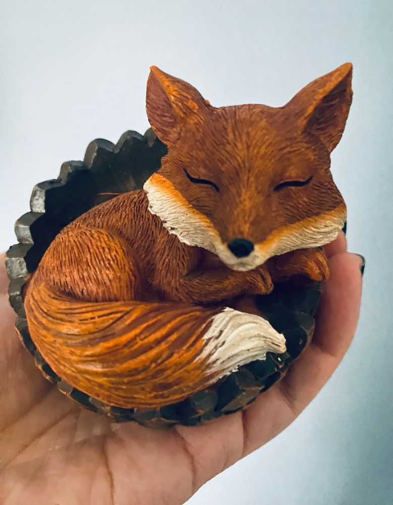 This cute ass figurine of a fox curled up in an acorn 