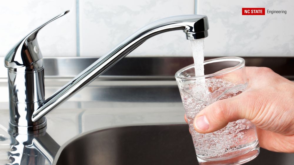 A glass of water is filled from a sink.