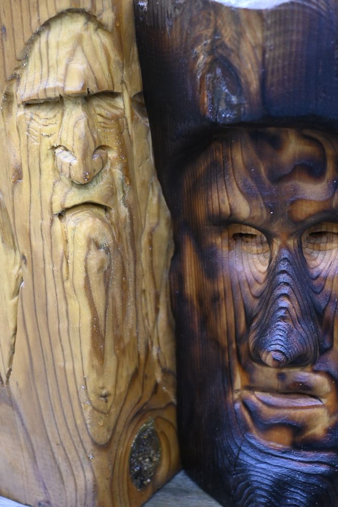 Wood carvings of moody old wise men.
