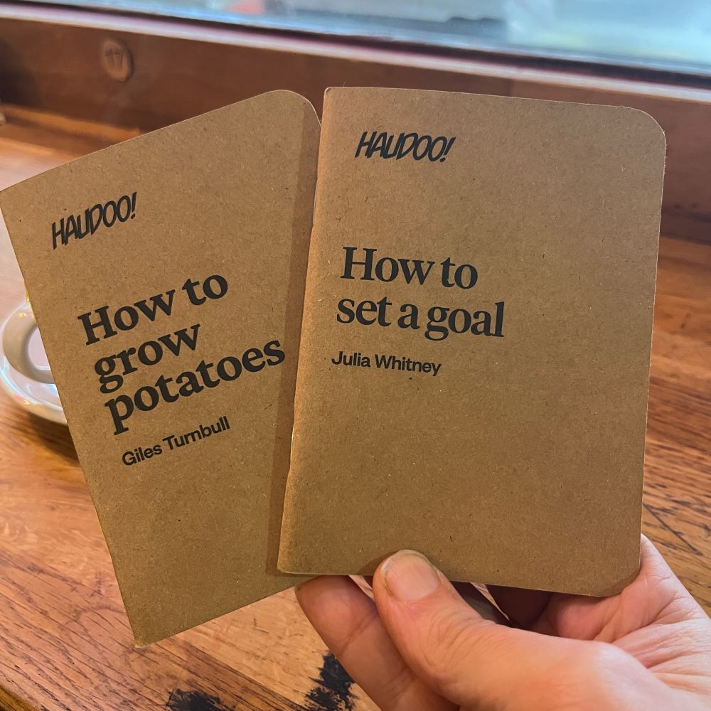 A photo of two small pamphlets. One called How to grow potatoes by Giles Turnbull. One called How to set a goal by Julia Whitney 