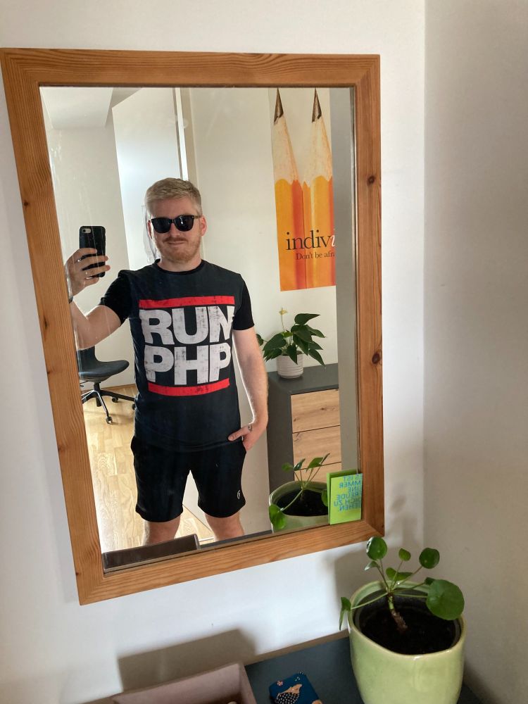 A mirror selfie of myself in sportswear and a Shirt saying "Run PHP" on it. It looks like the logo of the Hip Hop group Run DMC.
