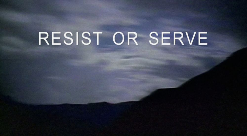 A screenshot from The X-Files opening credits of an alternate tagline against a cloudy sky. It reads, Resist or Serve. 