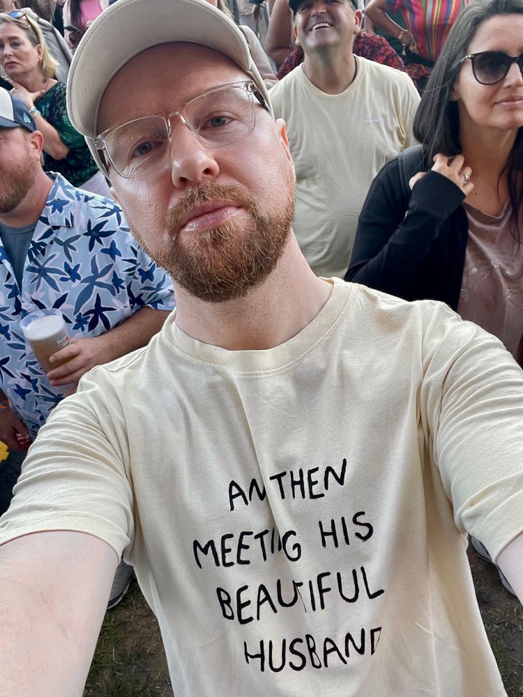 Selfie of me at a concert wearing a t shirt that says “and then meeting his beautiful husband”