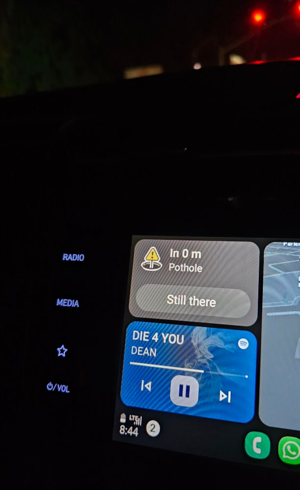 Image of a dashboard notification from Waze for a Pothole ahead. Showing how bad the roads are 