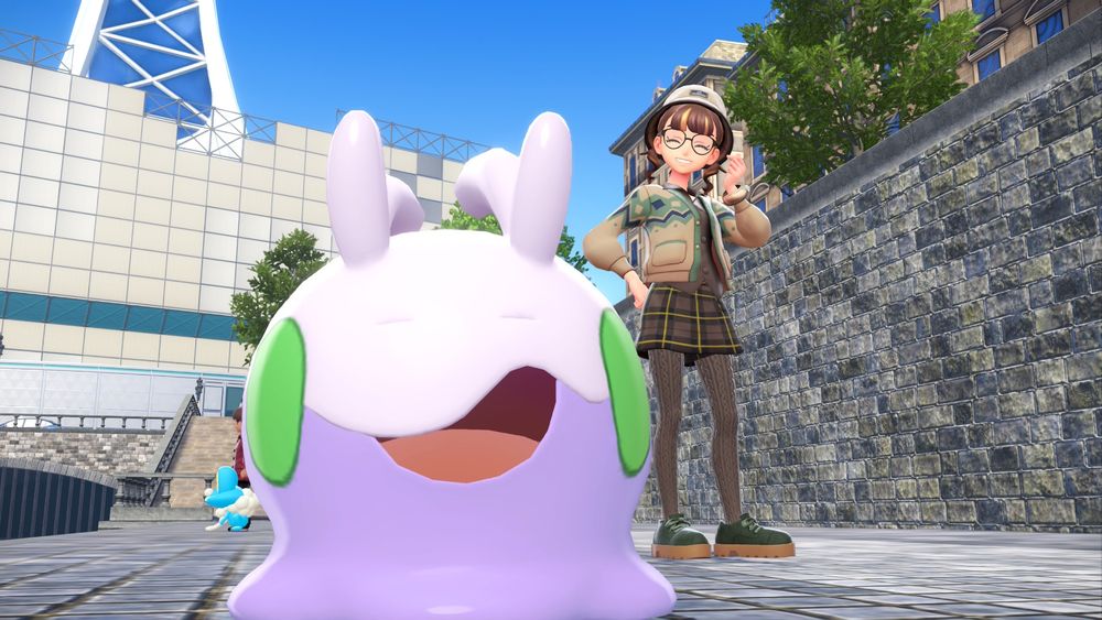 A female pokemon trainer with an alpha goomy