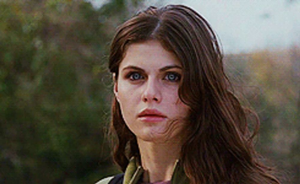 a close up of a woman 's face with long brown hair