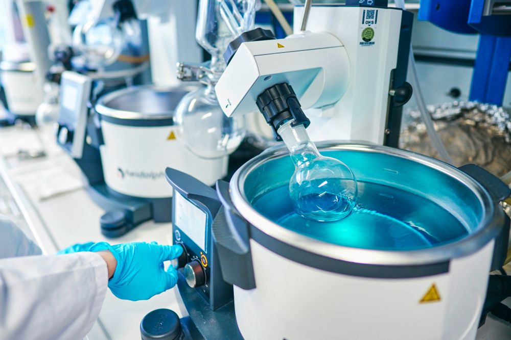 The device shown in the image is a rotary evaporator, commonly known as a rotovap. It is used in laboratories for the gentle removal of solvents from samples by evaporation, typically under reduced pressure.