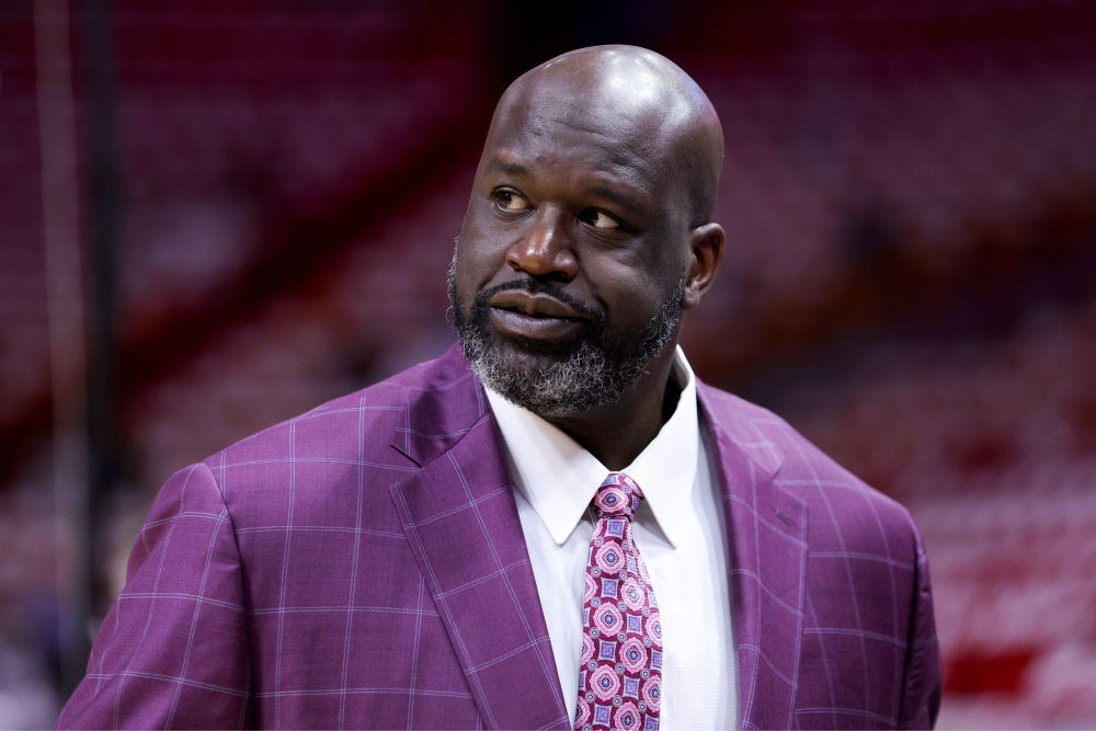 Shaquille O’Neal in a purple suit, purple tie.