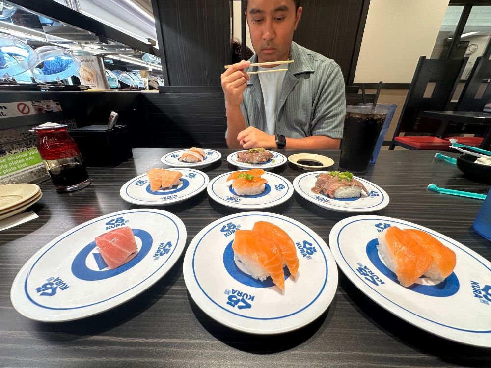 A photo of RJ looking at all the sushi we’re gonna eat