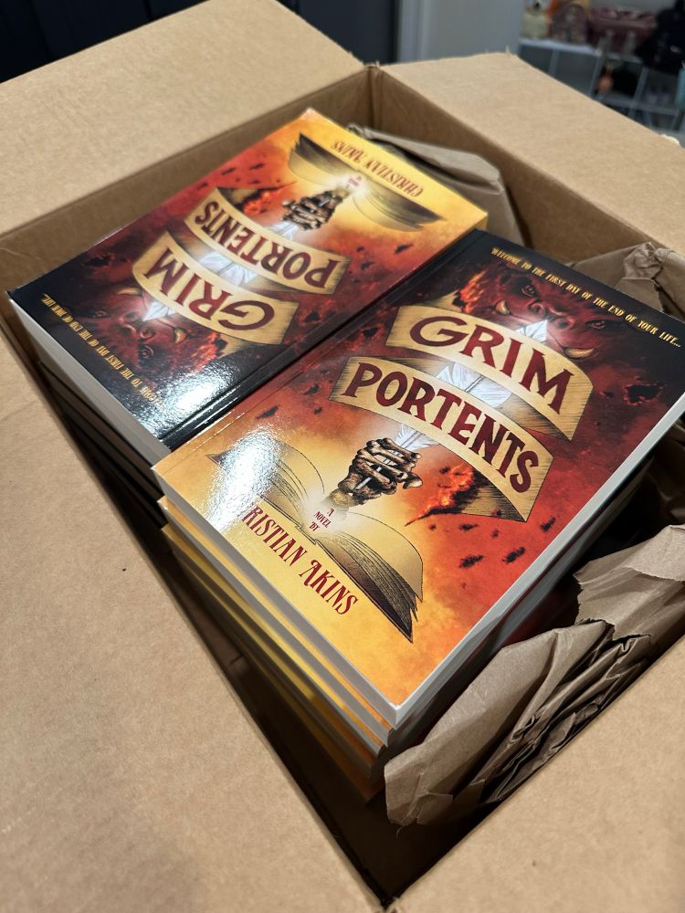 Box filled with copies of MY BOOK Grim Portents!
