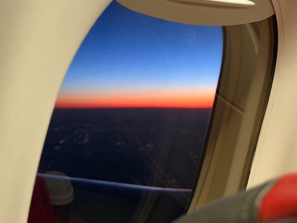 Sunrise viewed through the sad window of an embraer e170 
