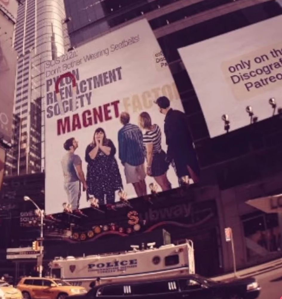 Collage of Pylon Reenactment Society’s album Magnet Factory imagined as a giant billboard in a bustling metropolis on the side of a building. A taxi, limo and Police bus are in the foreground. 