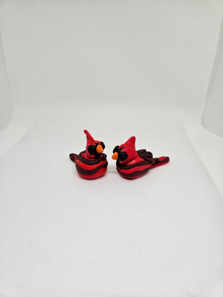 Two male cardinals done in miniature made from polymer clay 