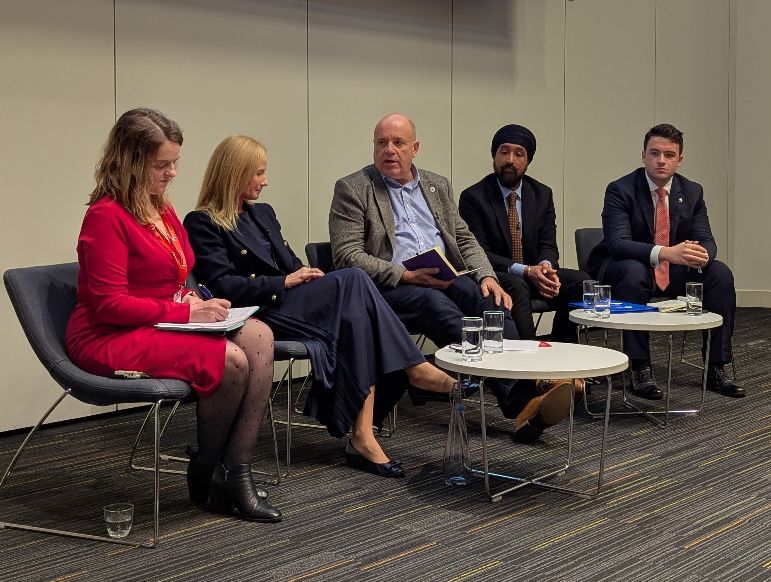 A panel of 5 people including Marc Crothall speaking
