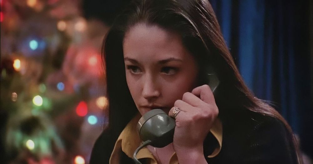 Olivia Hussey talking on the telephone in "Black Christmas," dir. Bob Clark 1974. A Christmas tree stands in the background behind her.