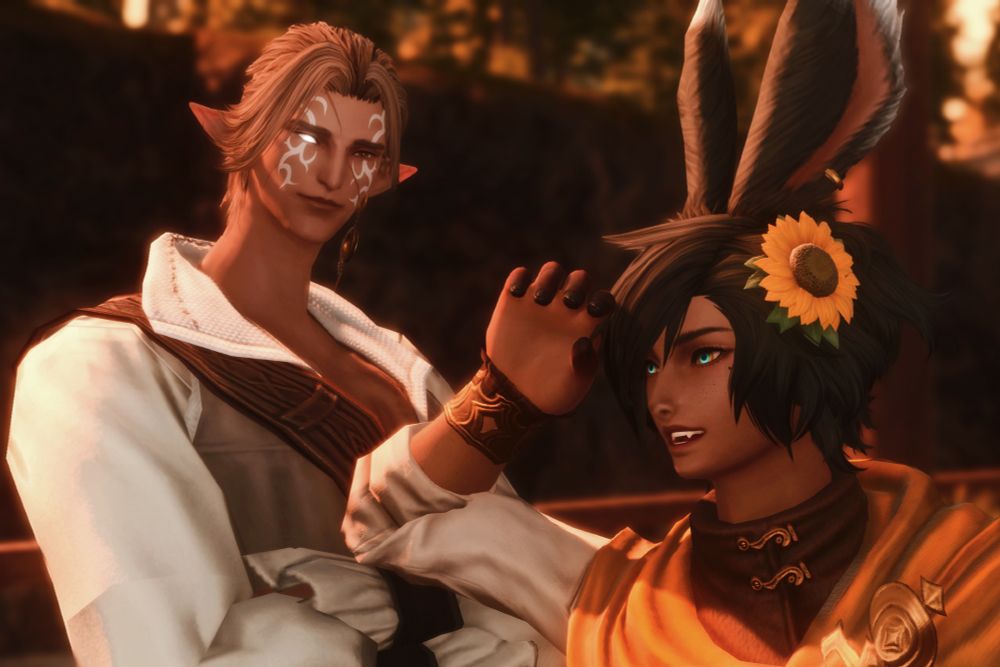 A photo of Milan (a male elezen from ffxiv) and Silver (a male Shetona from ffxiv). Silver has an expression of wonder and whimsy as he looks out towards the horizon. Milan's expression is warm, happy, and content. 