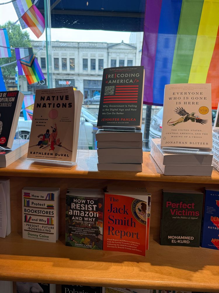 Recoding America displayed prominently on the top shelf at a bookstore.