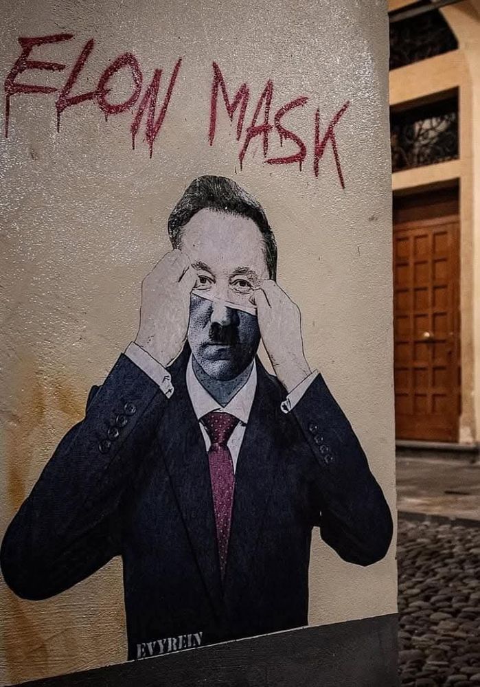 A painting of Elon Musk lifting his face (mask) off to reveal Hitler with the words Elon Mask above. 