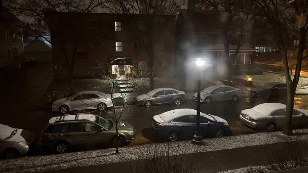 An Uptown Minneapolis street scene with snow on cars