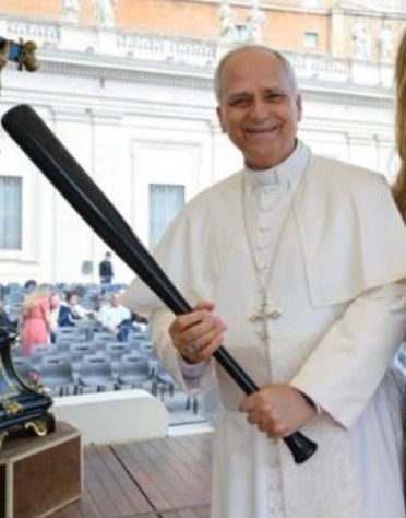 Pope Leo XIV holding a baseball bat.
