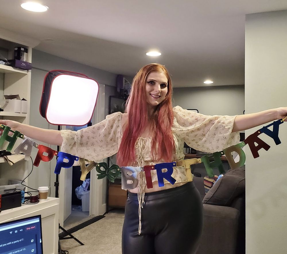 Photo of Aenne holding a "Happy Birthday" sign