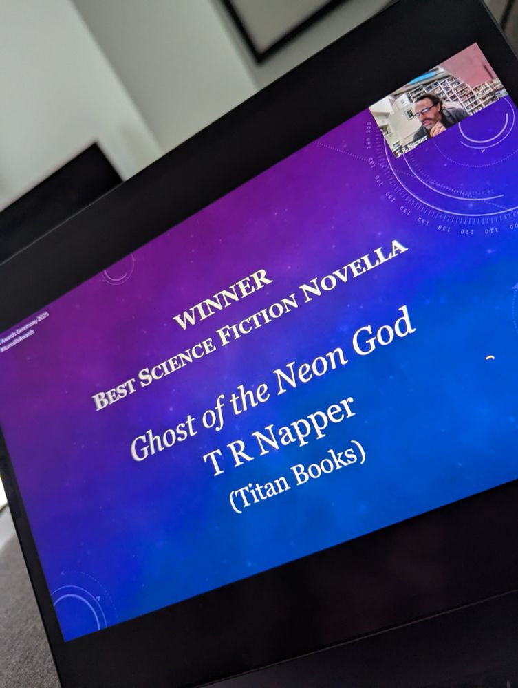 Screen shot of Aurealis Awards - TR Napper receiving award for Best Science Fiction Novella for Ghost of the Neon God (Titan Books).