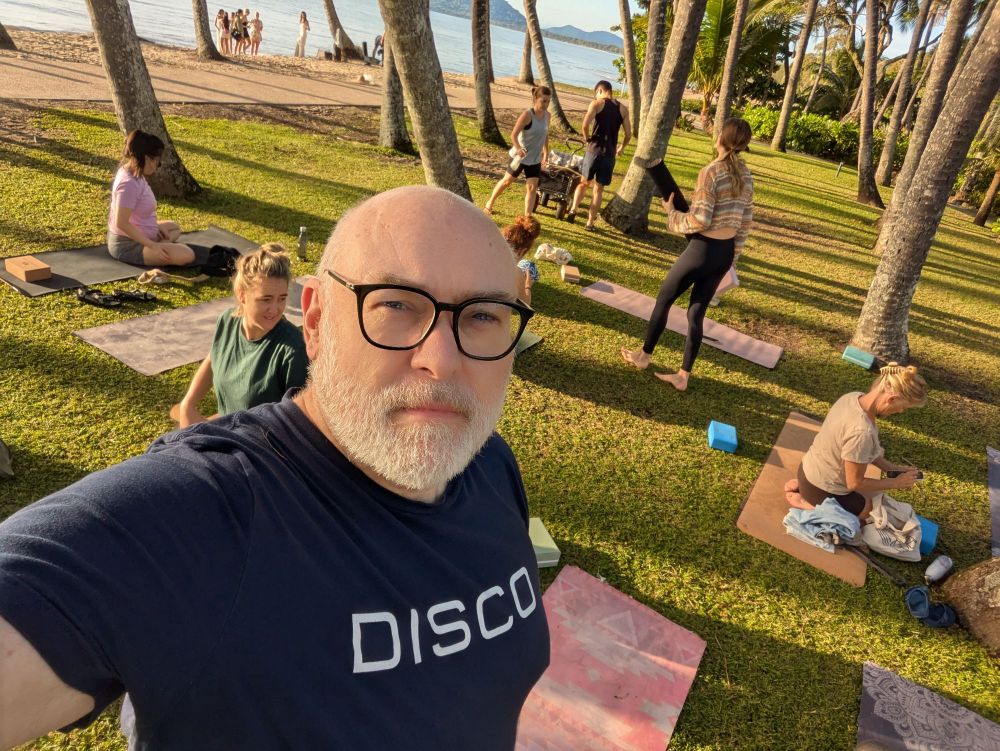 Selfie at the beach yoga while people are rolling up their mats. 