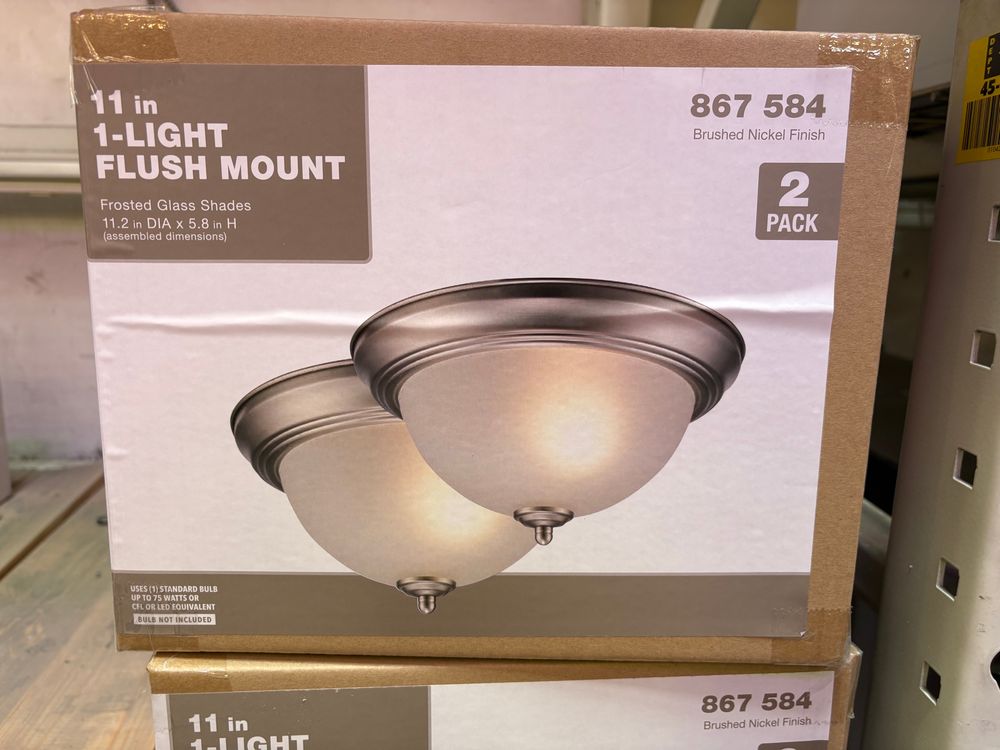 A box with two breast-shaped ceiling lights on its label. 