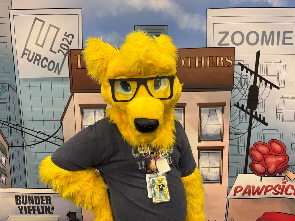 A golden retriever fursuit with glasses and a t-shirt.