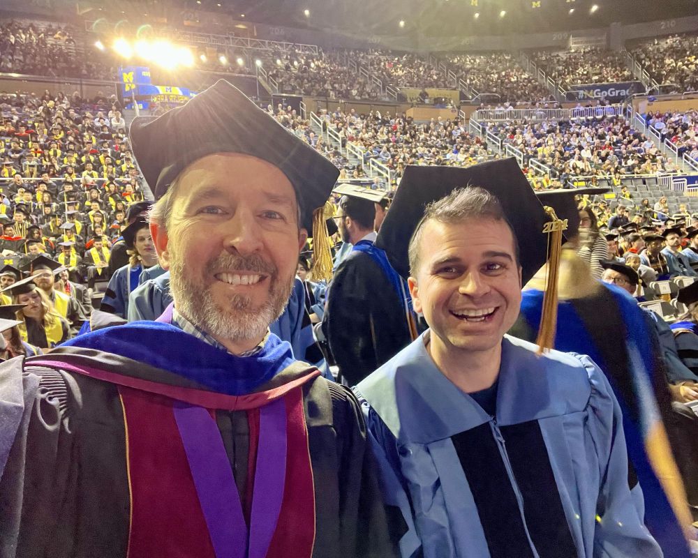 Matt Mulligan and Brian Umberger in academic regalia at the University of Michigan winter commencement.