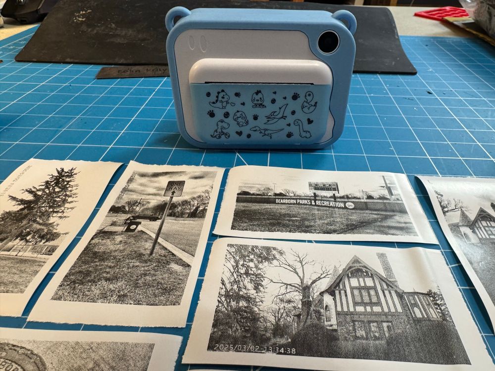 Blue camera for children with some pictures I. The foreground. 