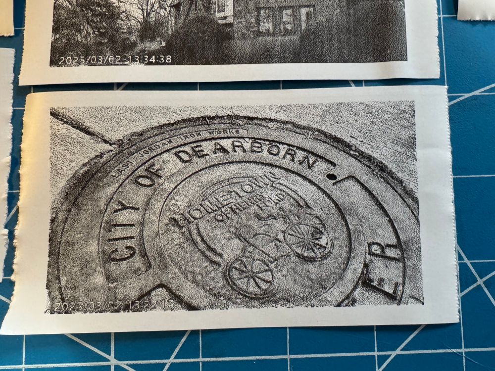 Thermal print of a man hole cover featuring an antique car in the Hometown of Henry Ford