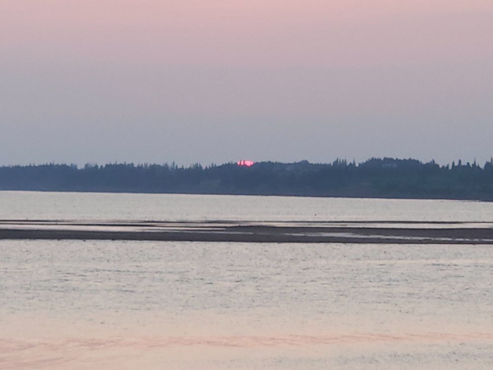 Sun finishing setting. Only a very thin sliver remains. 