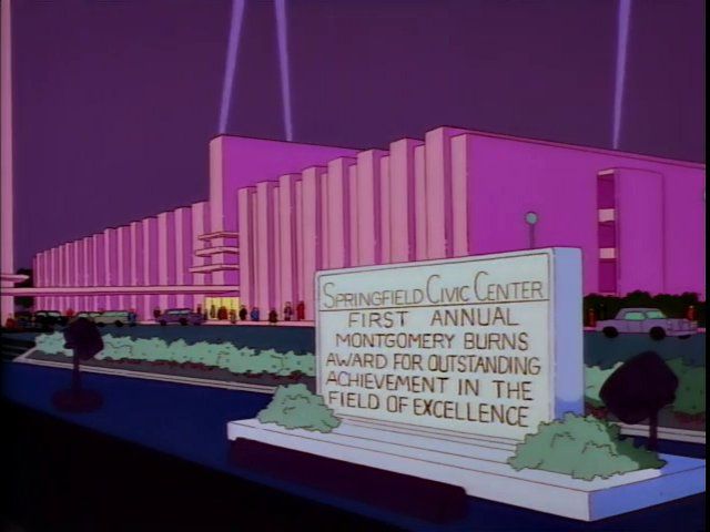 Springfield Civic Center sign: “First Annual Montgomery Burns Award for Outstanding Achievement in the Field of Excellence” 
