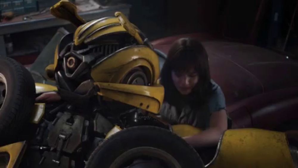 a man is working on a bumblebee transformer in a garage